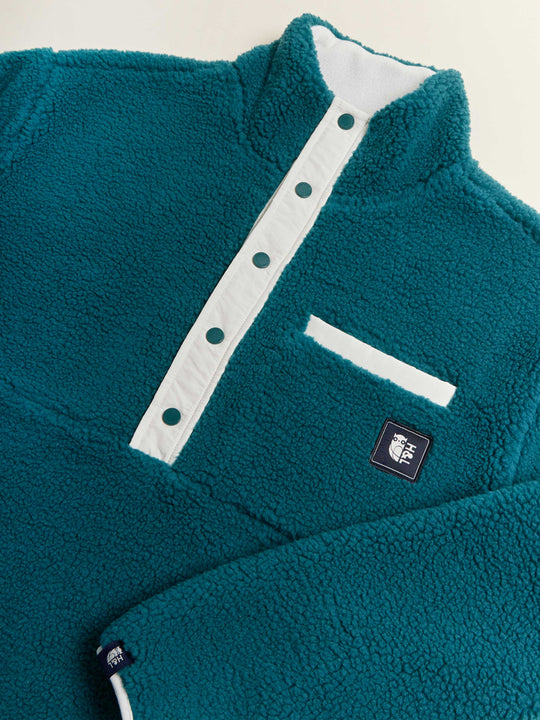 Hawthorn Sherpa fleece showing details of the cream button placket, pocket opening and sleeve detail.