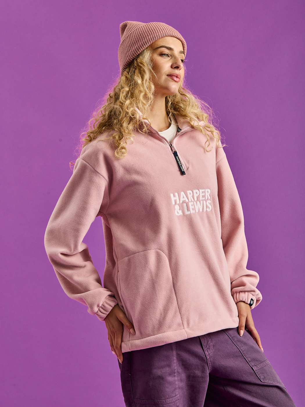 Female Model wearing the Plain Pink Fleece with the matching beanie hat.