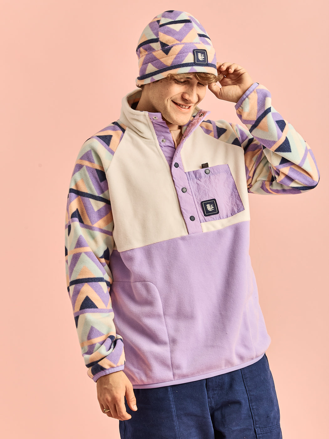 Male Model dressed in a lavender fleece jacket and matching hat, emphasizing the cozy material of the jacket.