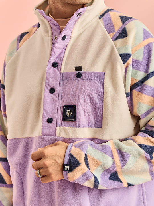 Close up of the details, this features a badge on the front crinkle pocket and a badge on the cuff.