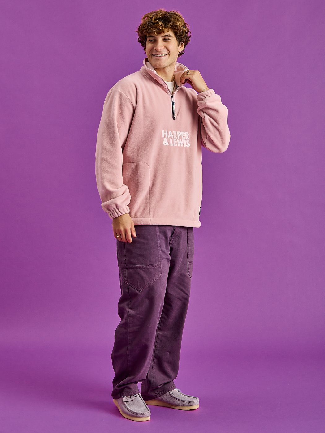 Full Length shot of the model wearing the Elsa Fleece, with Light Pink Binding around Zip, Collar.