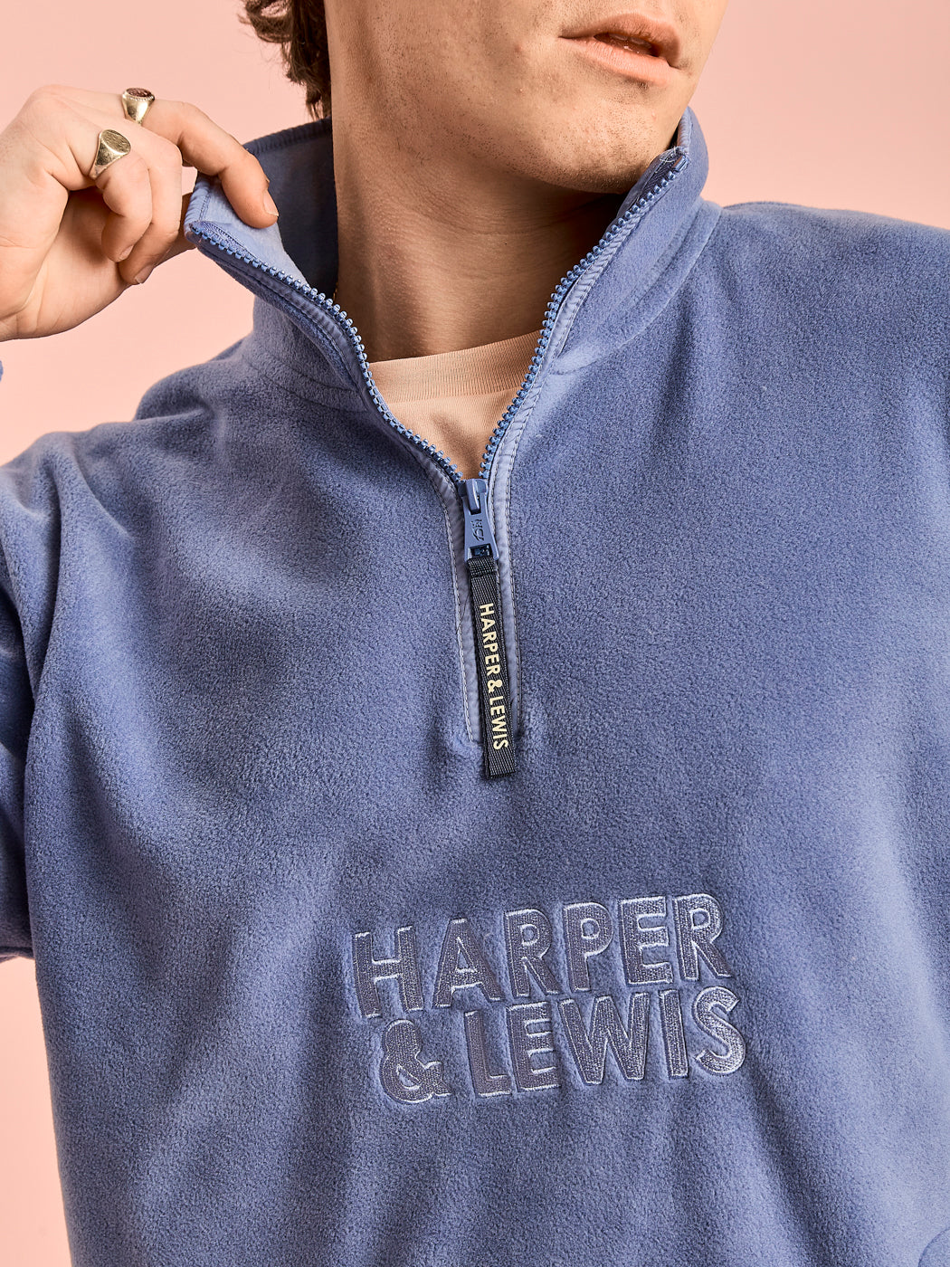 Detail shot of the embroidered 'Harper & Lewis' logo and the navy branded zip puller.