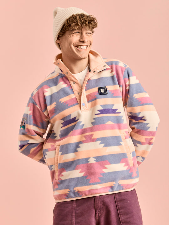 Male model wears the polar fleece jacket which has light peach binding on the sleeves and the hem