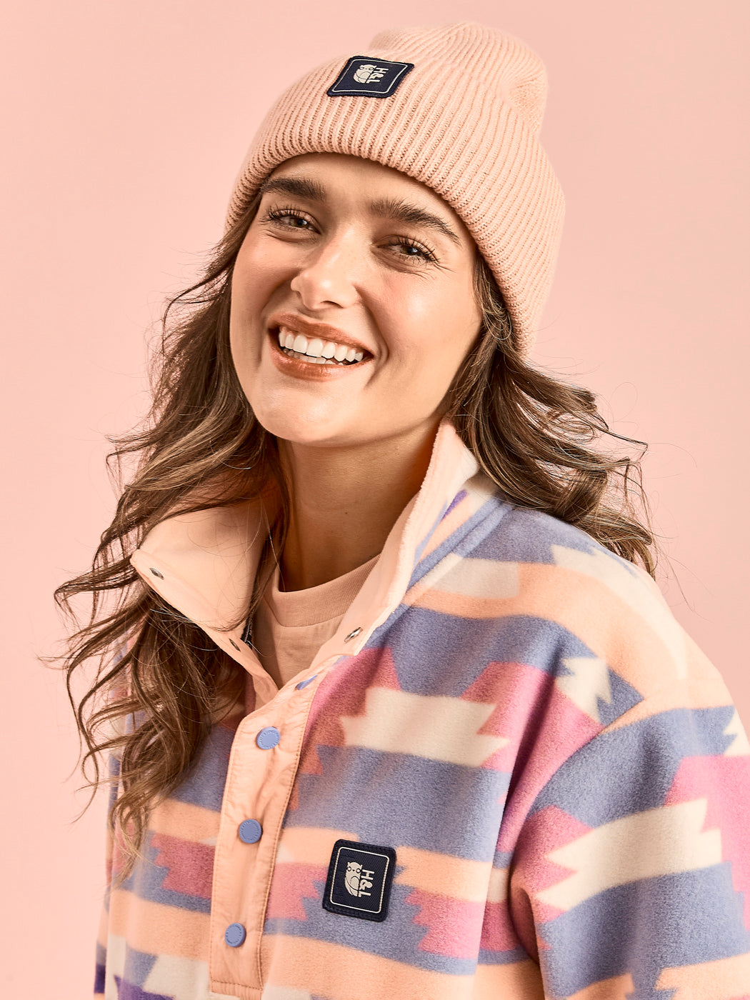 Detail shot of the Tribal pattern unisex fleece which shows the light peach placket with blue poppers