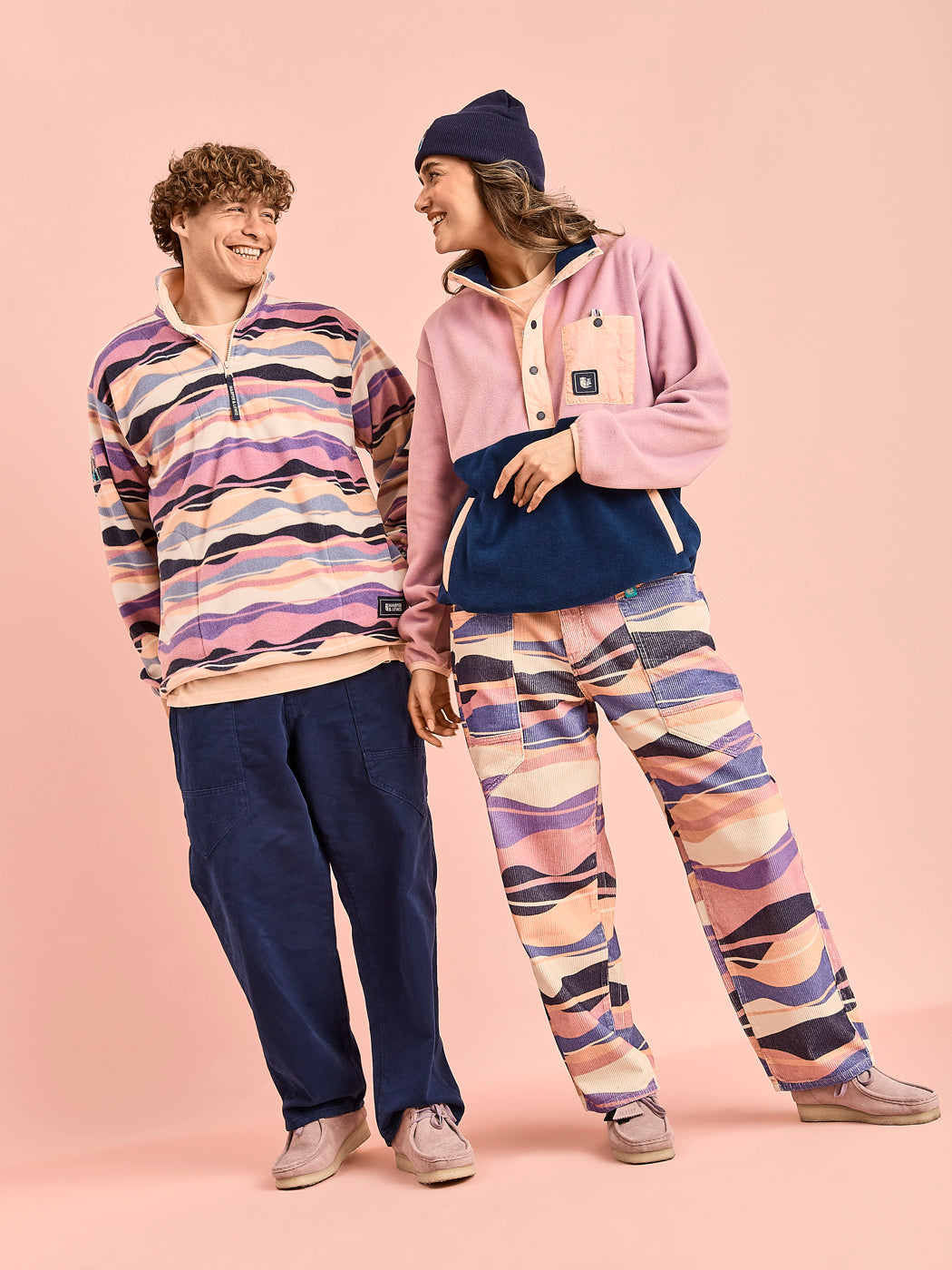 Two models wearing colourful fleeces from our latest collection.