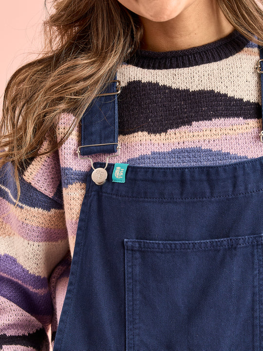 Detail shot of the adjustable brace straps and branded tab in teal