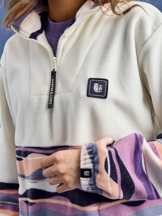 Detail shot of the branded zip puller and a branded woven Harper & Lewis badge.