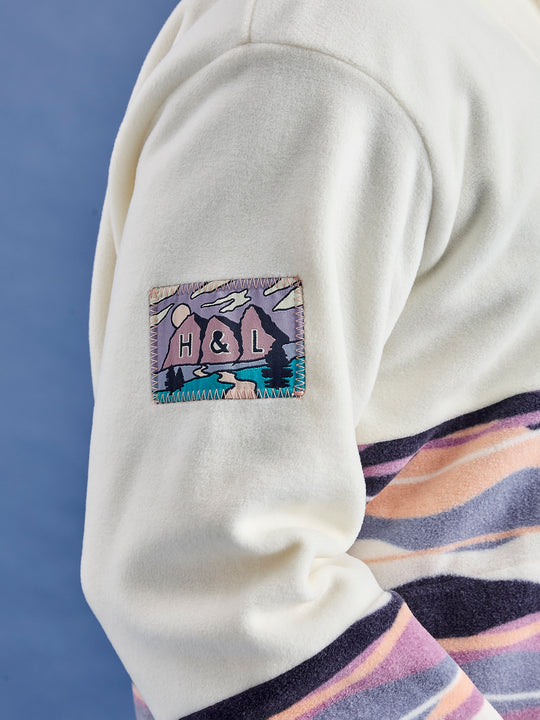 Details show the branded Harper & Lewis mountain inspired patch on the arm of the unisex fleece