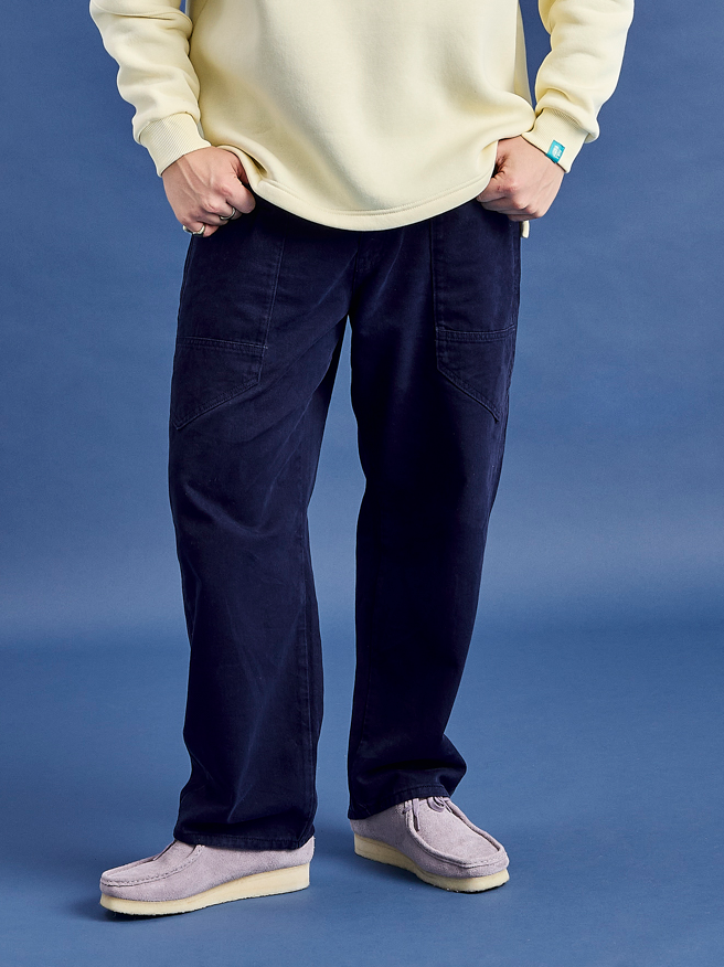 Asani Twill Trousers in Navy. These trousers combine a relaxed silhouette with durable style, ideal for both smart-casual wear and versatile outfits.