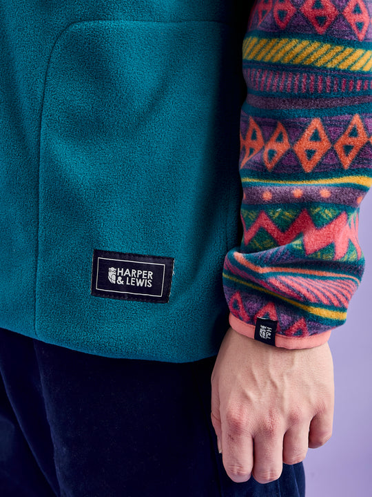 Detailed image of the navy branded patches on the front pocket and the sleeve.