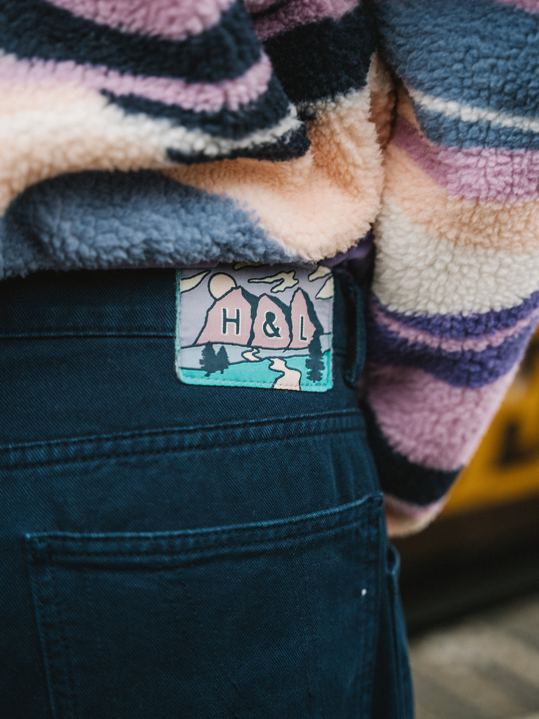 Detail shot of the Twill trousers, this shows the branded mountain inspired patch on the waitband